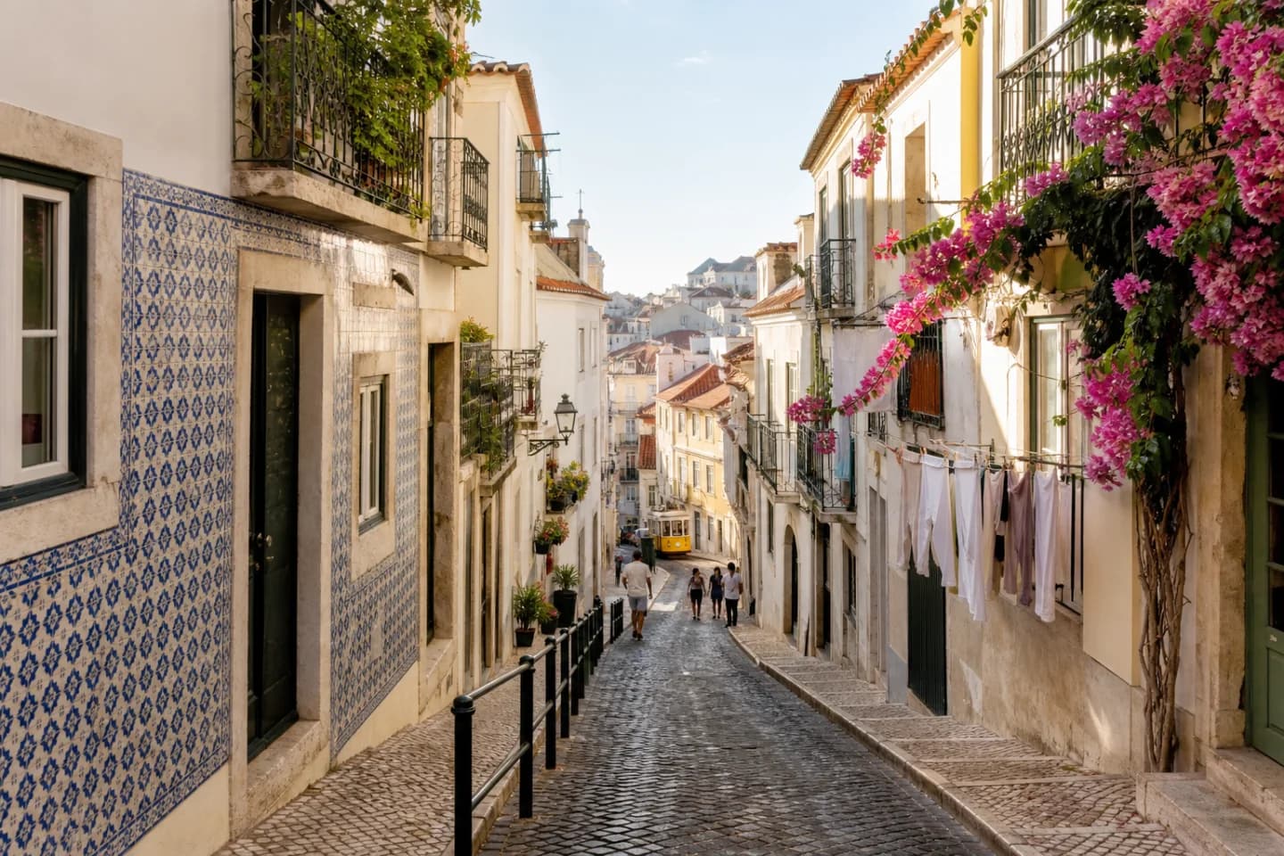 Sunlit tiled buildings rising through the hills of Alfama in Lisbon